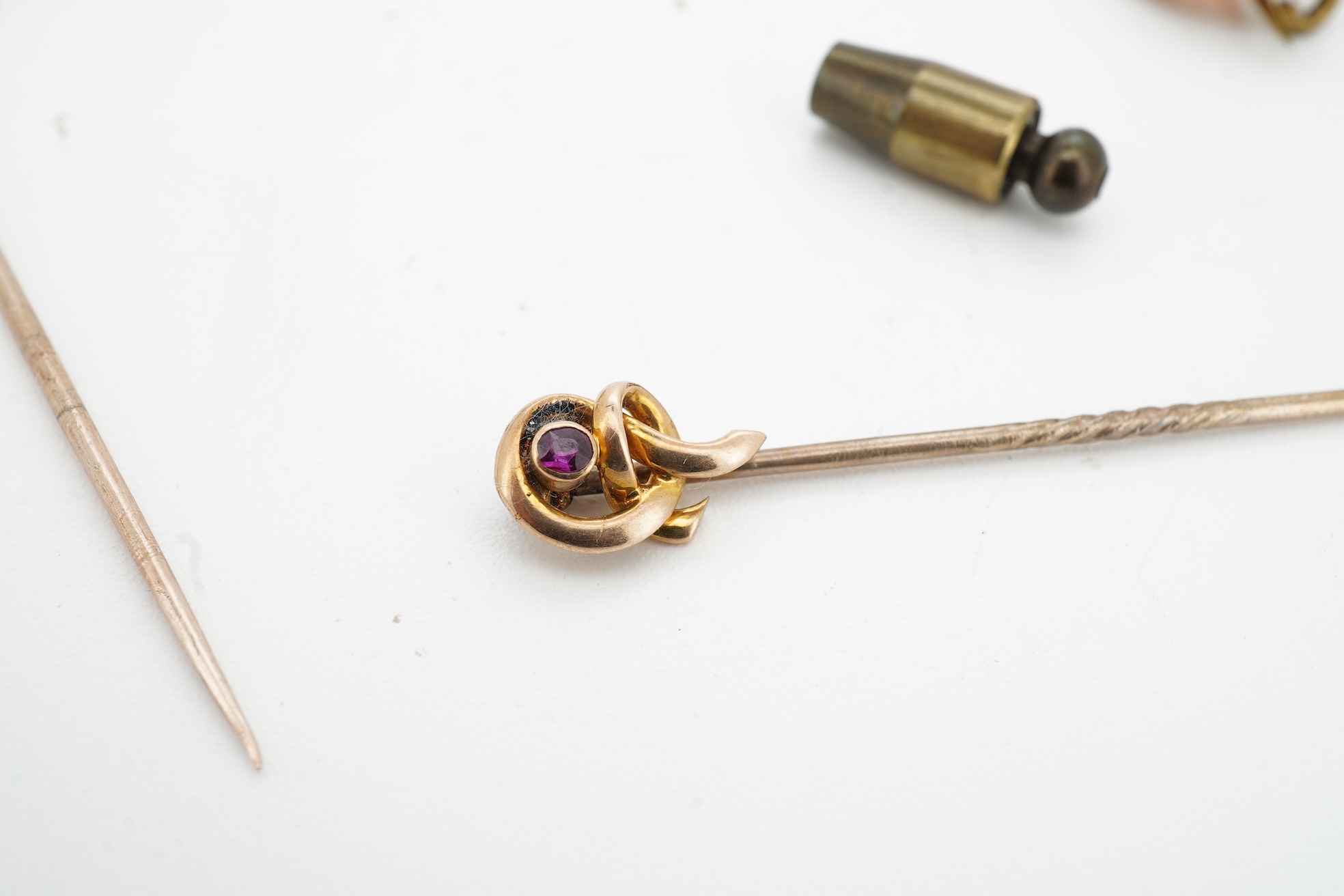 A collection of jewels, comprising: a stick pin, capped with the 'C' cipher with crowned ostrich feather and 'Ich Dien' motto for King Charles when Prince of Wales, in varicoloured gold and enamel, length 6.9cm, gross we